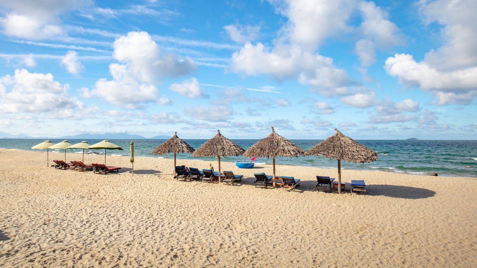 An Bang Beach in Hoi An with sandy shore, umbrellas, and sea view.