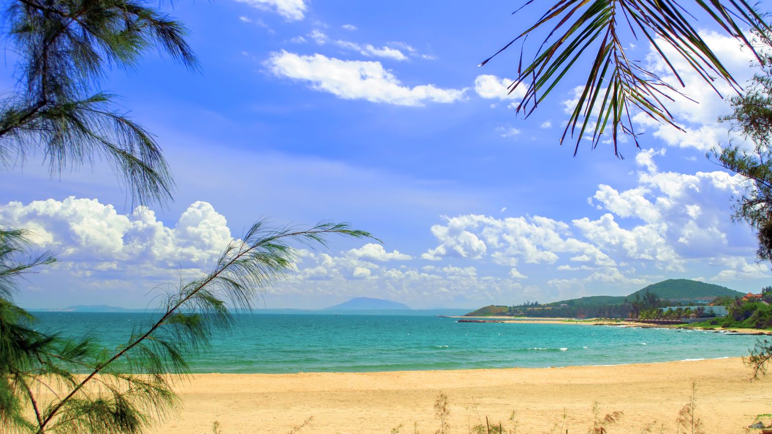 Peaceful Mui Ne Beach with long sandy shore and gentle waves in Vietnam