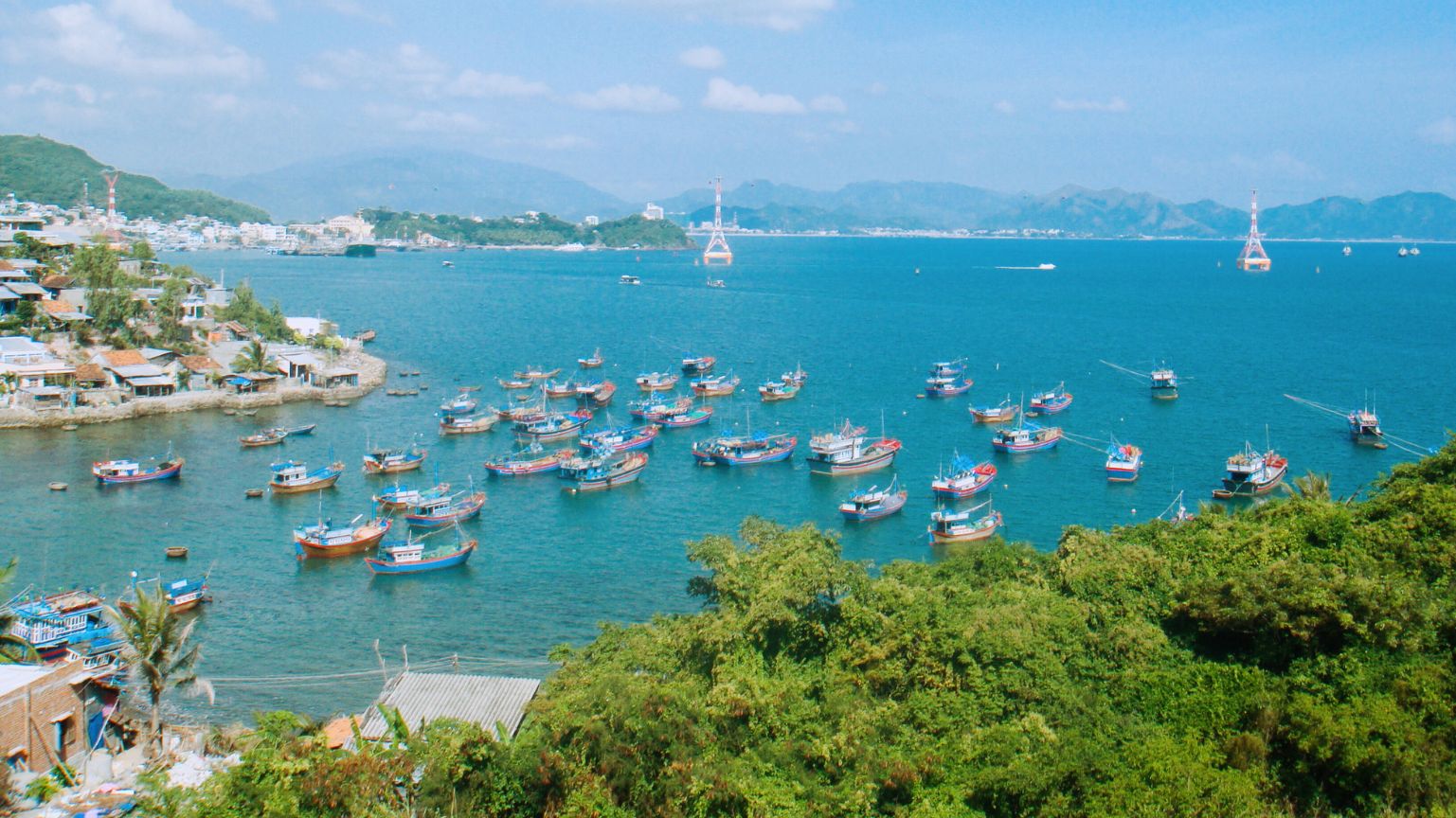 Fishing boats anchored in the calm bay of Nha Trang Beach, Khanh Hoa
