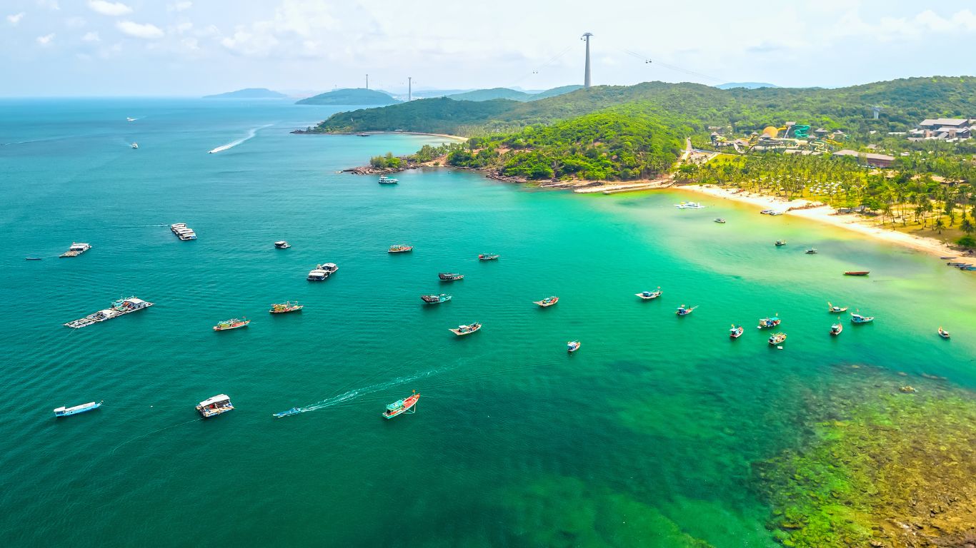 Aerial view of Phu Quoc island Vietnam with turquoise sea fishing boats and a tropical coastline with white sandy beach