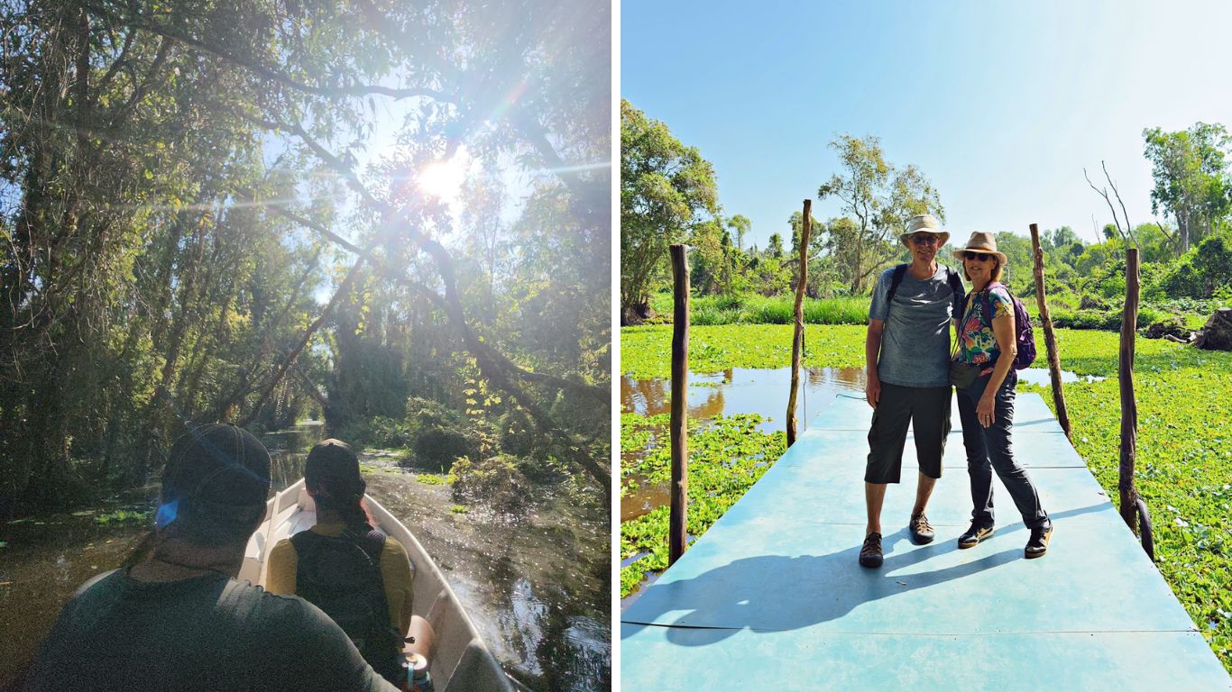 Tra Su Cajuput Forest in Chau Doc, Mekong Delta, showing tourists on a boat gliding through a flooded forest tunnel and a couple standing on a narrow walkway surrounded by green water hyacinth and wetland scenery in southern Vietnam.