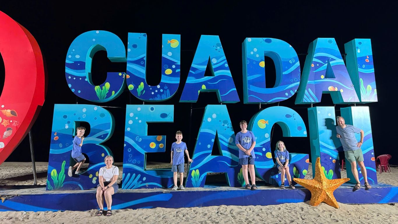family with kids at Cua Dai Beach Da Nang at night safe Vietnam beach holiday