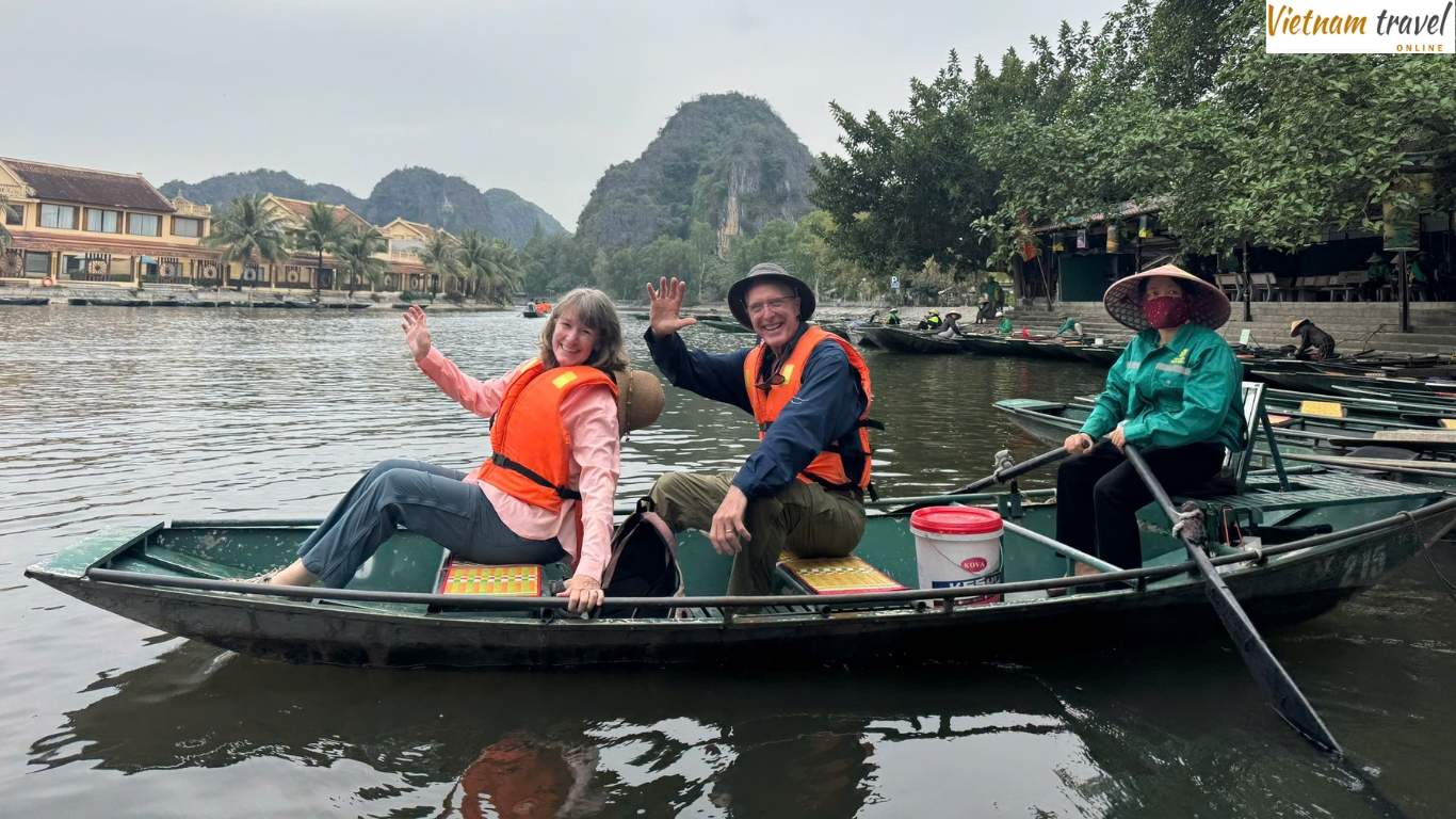 Tourists riding a rowboat during a Tam Coc boat trip in Ninh Binh